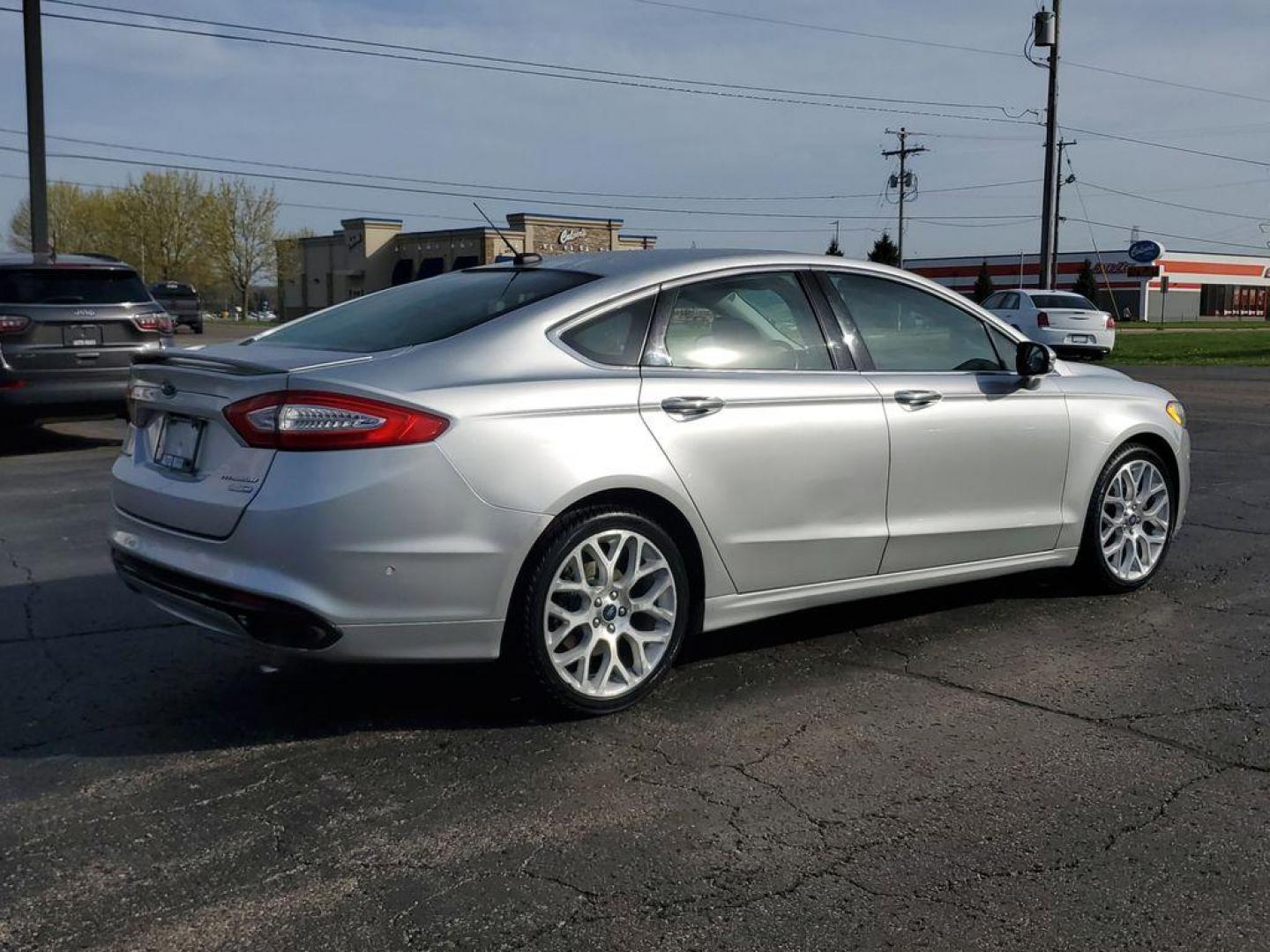 2014 Ingot Silver Metallic /Charcoal Black Ford Fusion Titanium AWD (3FA6P0D93ER) with an 2.0L L4 DOHC 16V engine, 6-speed automatic transmission, located at 6064 Gull Rd, Kalamazoo, MI, 49048, (269) 222-0088, 42.328388, -85.512924 - Discover the perfect blend of style, performance, and comfort with our 2014 Ford Fusion Titanium. This exceptional vehicle is equipped with all-wheel drive, ensuring confident handling and superior traction in all weather conditions. Under the hood, you'll find a robust 4-cylinder, 2.0L engine that - Photo#3