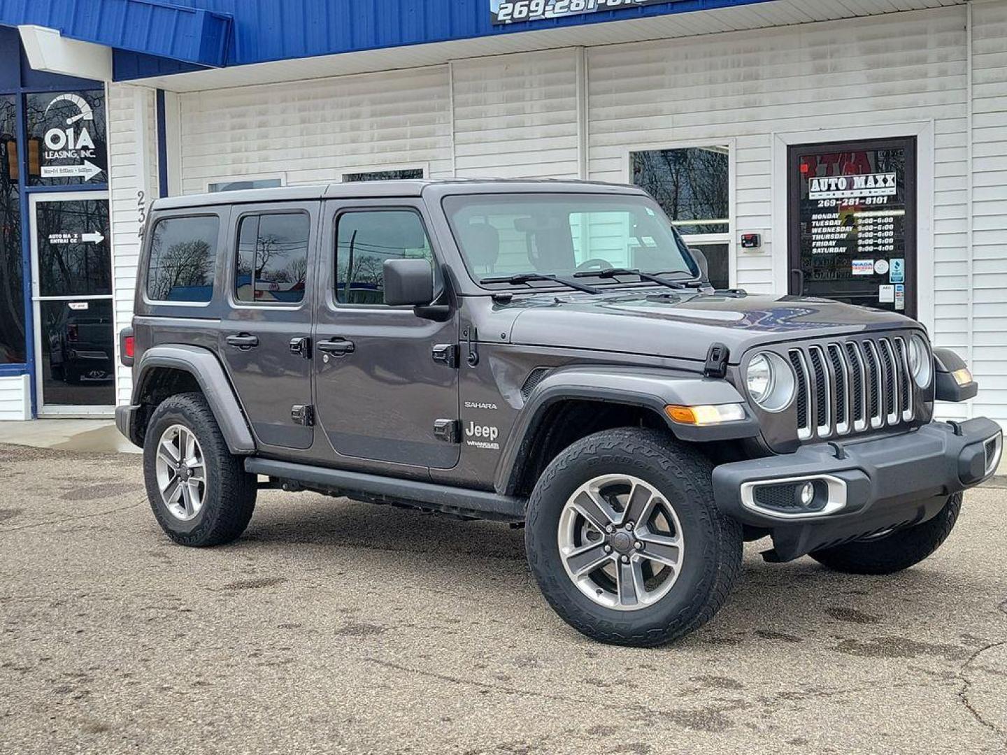 2018 Granite Crystal Metallic Clearcoat /Black Jeep Wrangler JK Unlimited Sahara (1C4HJXEG7JW) with an 3.6L V6 DOHC 24V FFV engine, 6A transmission, located at 234 Columbia Ave, Battle Creek, MI, 49015, (269) 222-0088, 42.298264, -85.192543 - <b>Vehicle Details</b><br>Discover adventure in this 2018 Jeep Wrangler Sahara, a perfect blend of ruggedness and comfort. Equipped with a powerful V6, 3.6L engine and 4WD, this versatile SUV is ready to conquer both city streets and off-road trails. Its classic design is complemented by modern feat - Photo#0