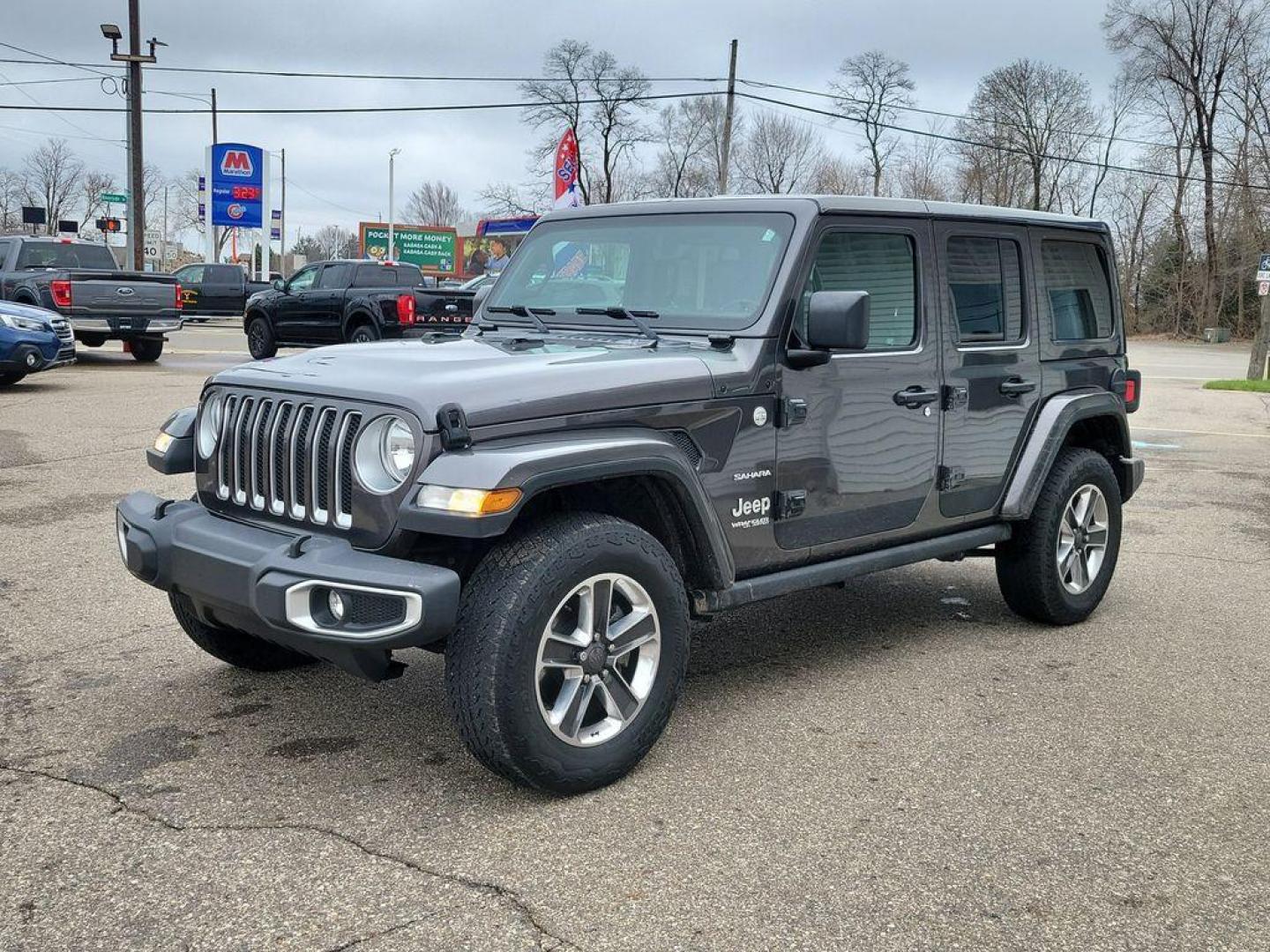 2018 Granite Crystal Metallic Clearcoat /Black Jeep Wrangler JK Unlimited Sahara (1C4HJXEG7JW) with an 3.6L V6 DOHC 24V FFV engine, 6A transmission, located at 234 Columbia Ave, Battle Creek, MI, 49015, (269) 222-0088, 42.298264, -85.192543 - <b>Vehicle Details</b><br>Discover adventure in this 2018 Jeep Wrangler Sahara, a perfect blend of ruggedness and comfort. Equipped with a powerful V6, 3.6L engine and 4WD, this versatile SUV is ready to conquer both city streets and off-road trails. Its classic design is complemented by modern feat - Photo#1