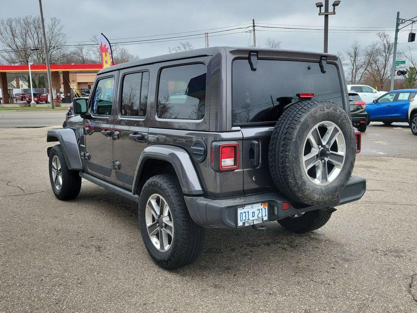 2018 Granite Crystal Metallic Clearcoat /Black Jeep Wrangler JK Unlimited Sahara (1C4HJXEG7JW) with an 3.6L V6 DOHC 24V FFV engine, 6A transmission, located at 234 Columbia Ave, Battle Creek, MI, 49015, (269) 222-0088, 42.298264, -85.192543 - <b>Vehicle Details</b><br>Discover adventure in this 2018 Jeep Wrangler Sahara, a perfect blend of ruggedness and comfort. Equipped with a powerful V6, 3.6L engine and 4WD, this versatile SUV is ready to conquer both city streets and off-road trails. Its classic design is complemented by modern feat - Photo#2