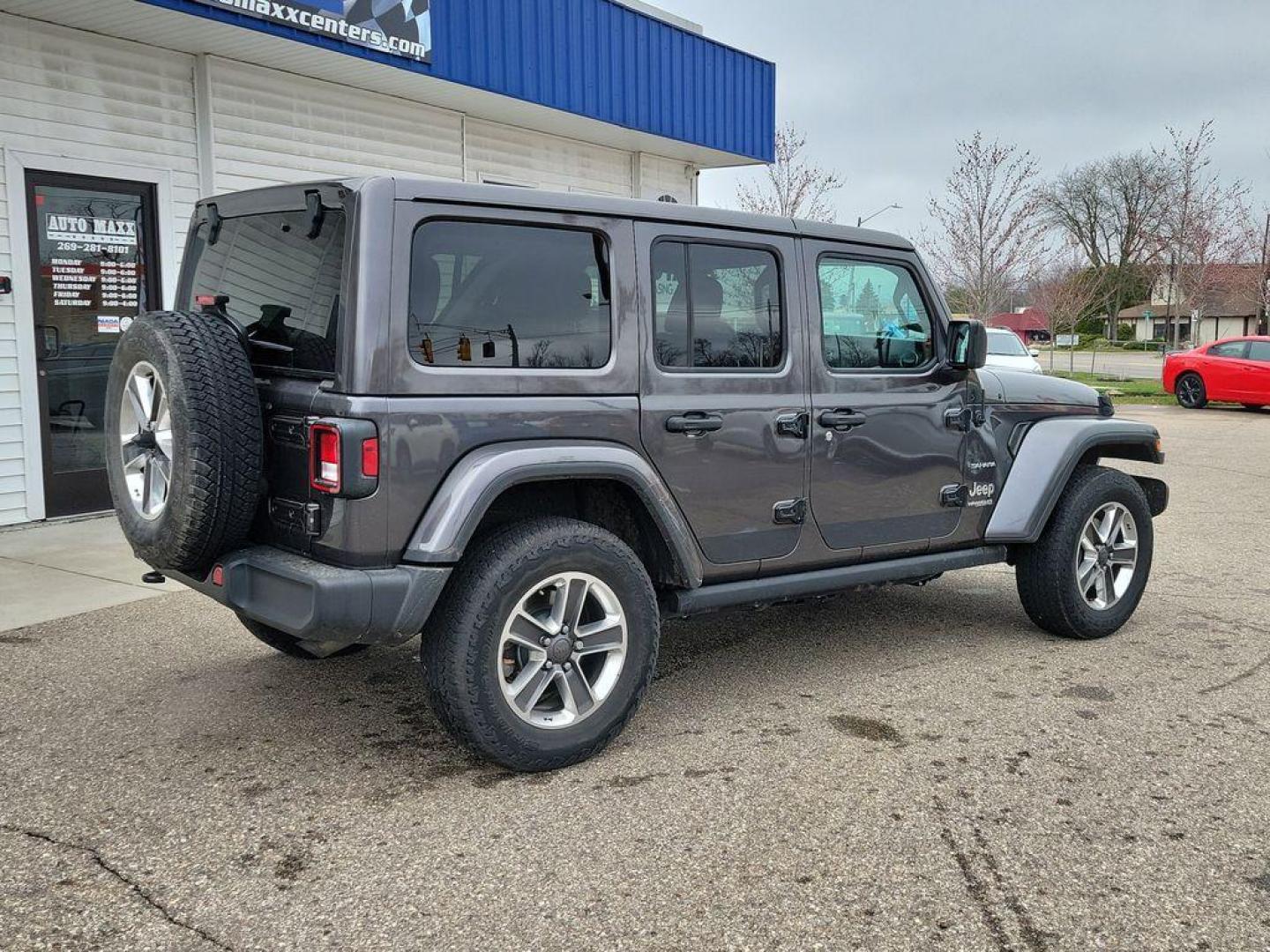 2018 Granite Crystal Metallic Clearcoat /Black Jeep Wrangler JK Unlimited Sahara (1C4HJXEG7JW) with an 3.6L V6 DOHC 24V FFV engine, 6A transmission, located at 234 Columbia Ave, Battle Creek, MI, 49015, (269) 222-0088, 42.298264, -85.192543 - <b>Vehicle Details</b><br>Discover adventure in this 2018 Jeep Wrangler Sahara, a perfect blend of ruggedness and comfort. Equipped with a powerful V6, 3.6L engine and 4WD, this versatile SUV is ready to conquer both city streets and off-road trails. Its classic design is complemented by modern feat - Photo#3